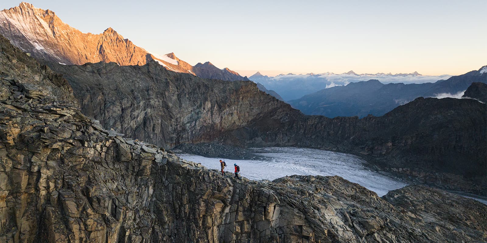 hikers hiking along mountain ridge on the Saas Mountain Hut Tour