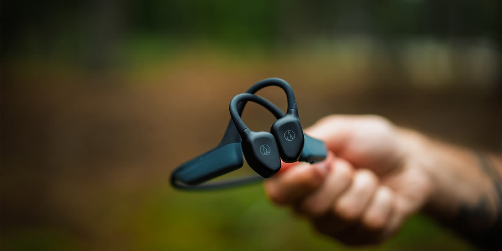 close up shot of the buttons on a open-ear bluetooth headphone from Audio Technica