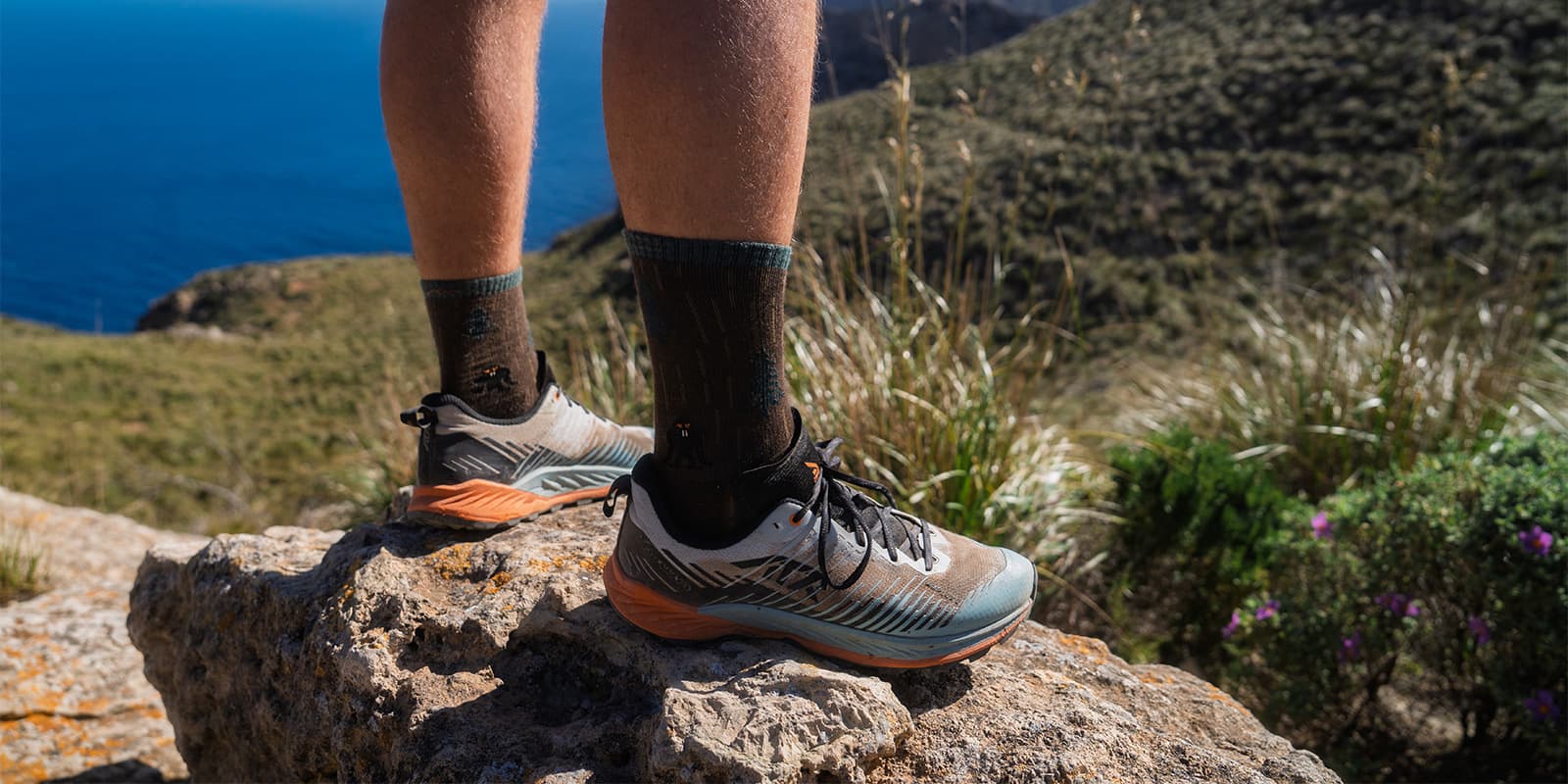 person standing on rock wearing the LOWA Amplux 2