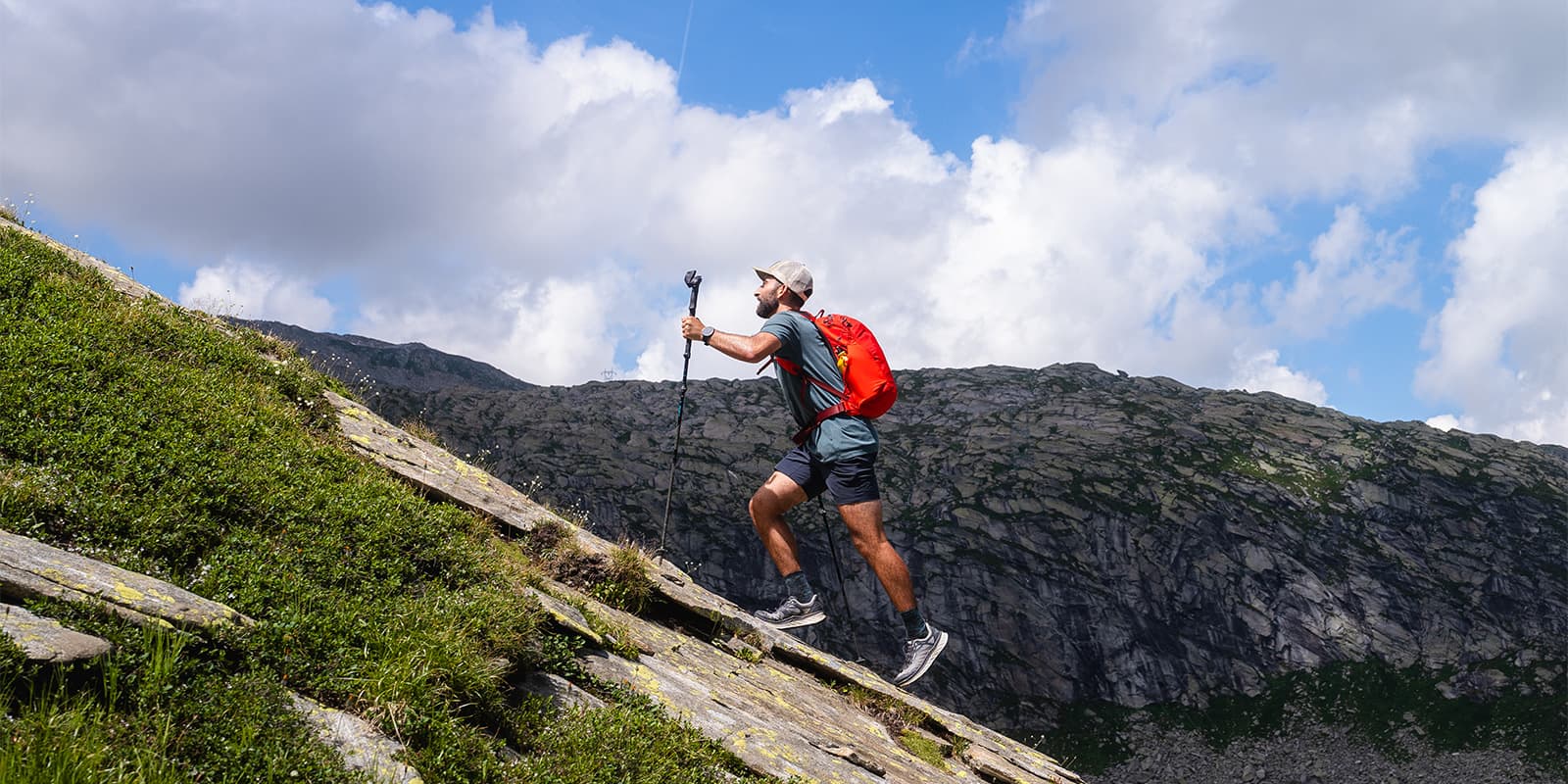 person hiking up steep mountain